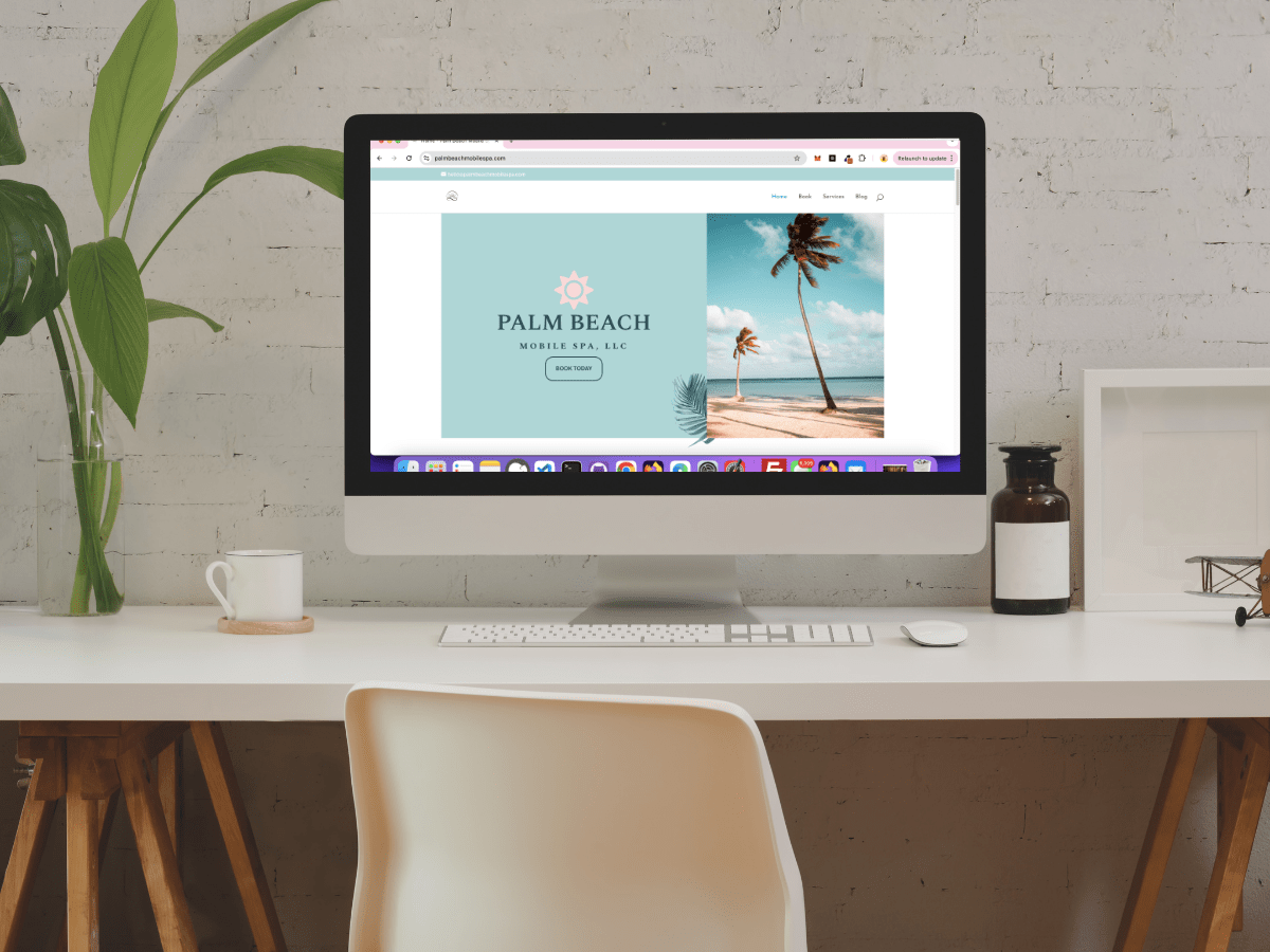 how to make your WordPress website live, image of computer sitting on top of a desk with a plant.
